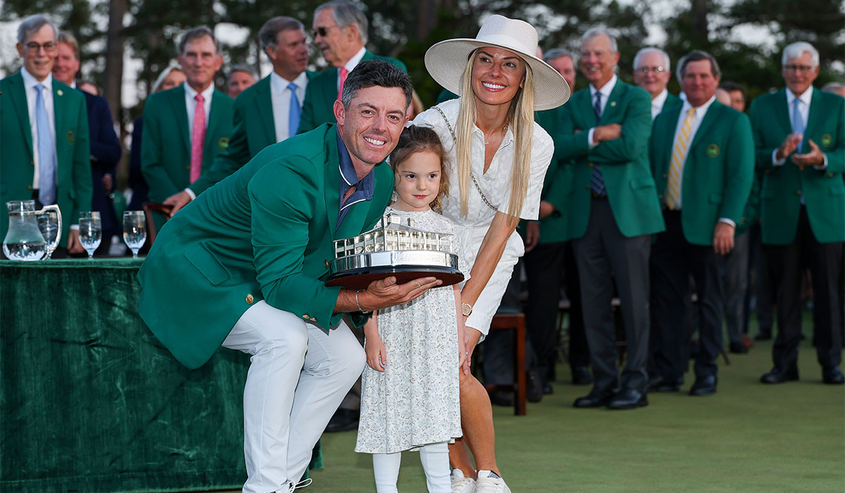 Rory McIlroy of Northern Ireland poses with daughter Poppy and wife Erica Stoll holding the Masters trophy during the Green Jacket Ceremony after winning the 2025 Masters Tournament at Augusta National Golf Club. Pic: Getty Images